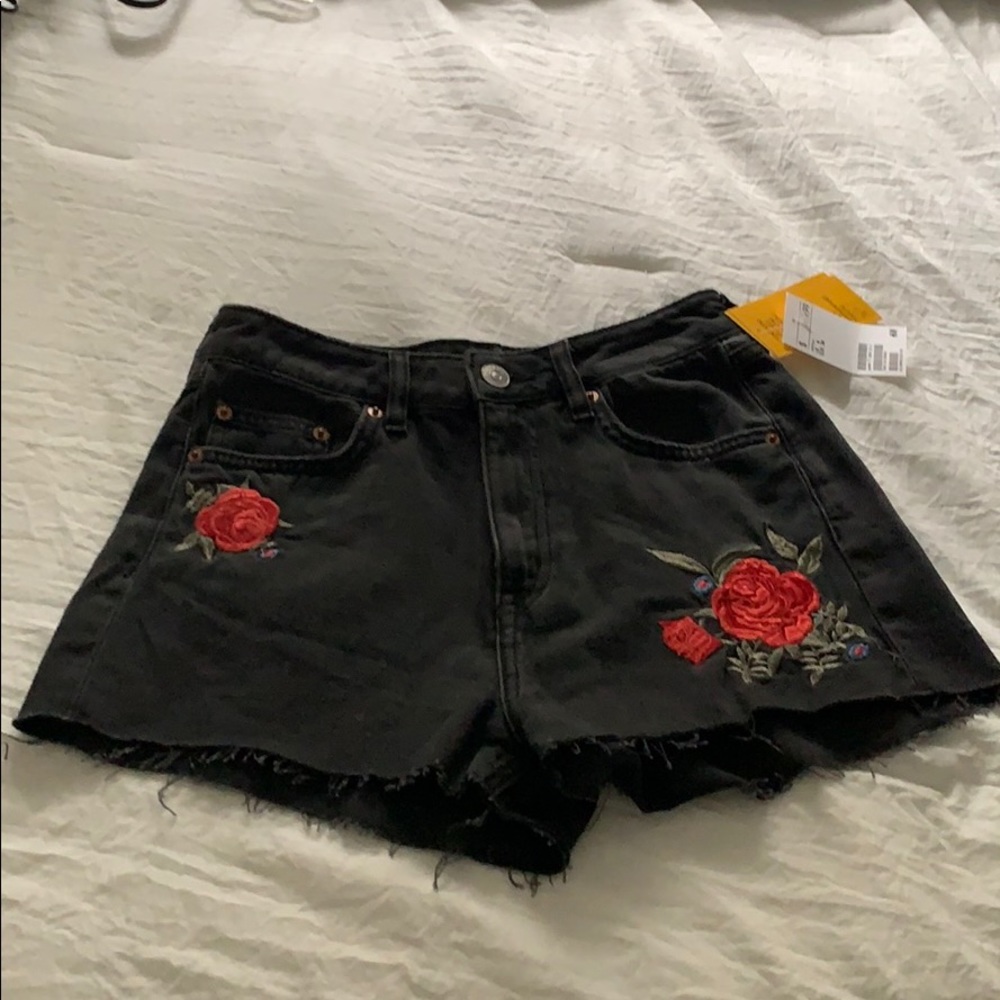 Black cut off jean shorts with floral design